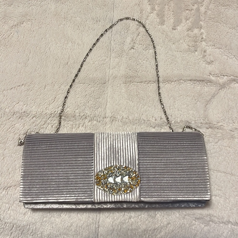 Silver evening purse with silver/gold bling on pocketbook.  Great condition!